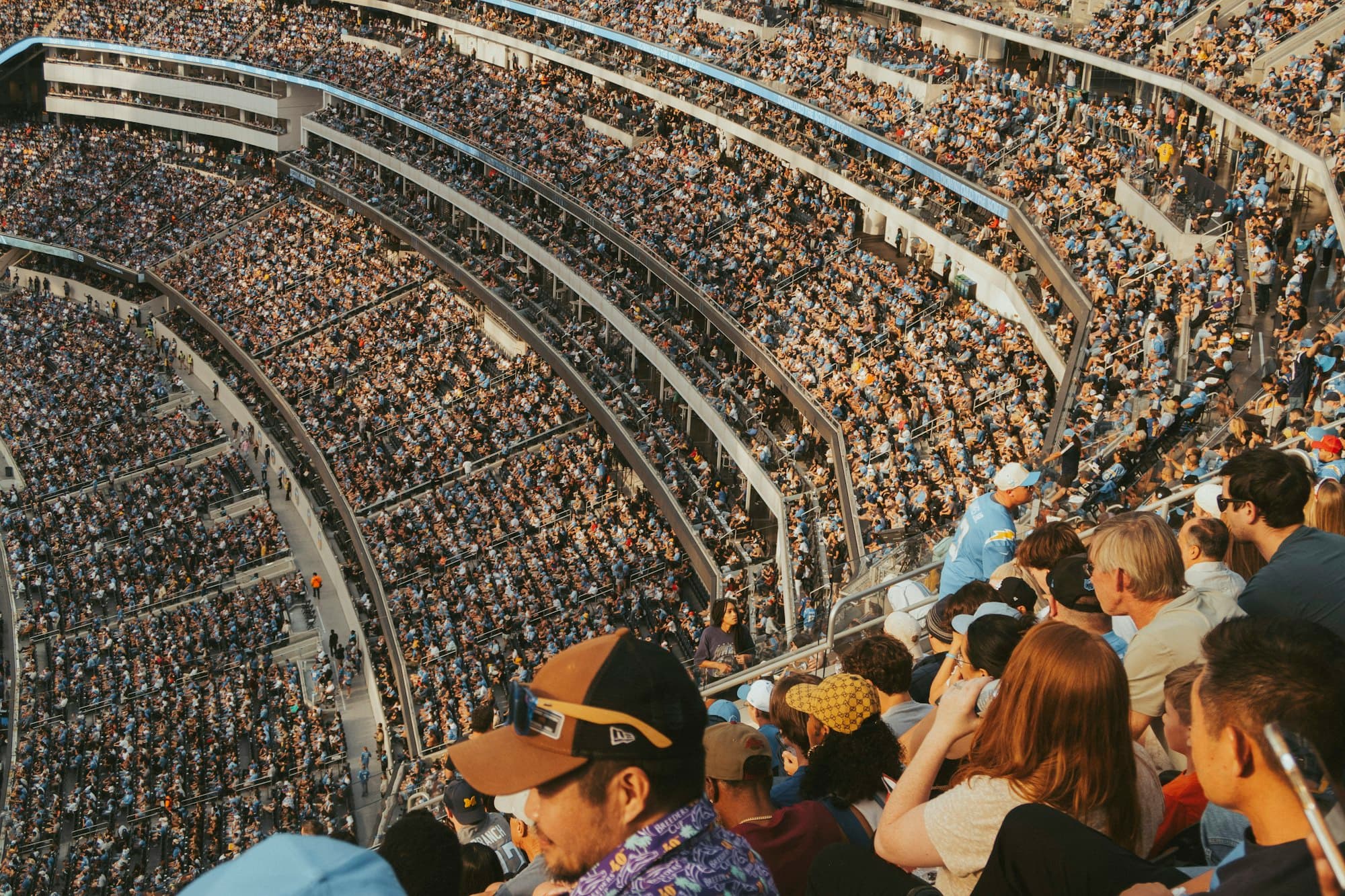 Fans filling the stands of a large stadium